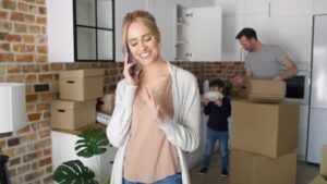 Woman calling junk removal company in Westchase to coordinate move after decluttering her home