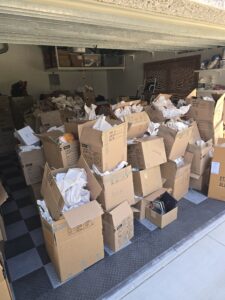 Before and after garage cleanout in Westchase FL showing cardboard box removal and a clean organized garage by Speedy Hauling & Junk Removal