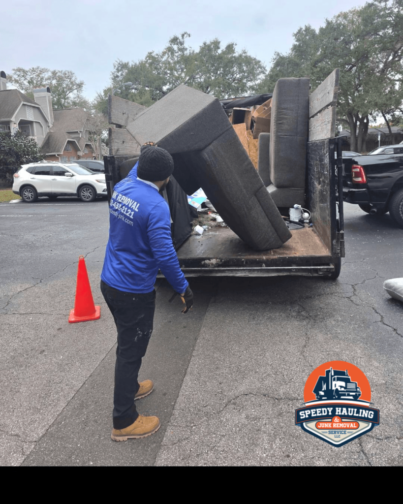 Speedy Hauling team member loading a couch for junk removal in Oldsmar Florida