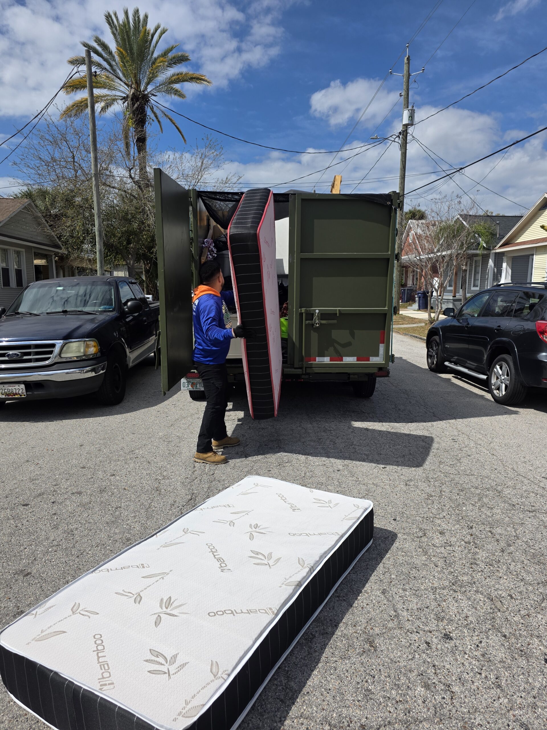 Speedy Hauling crew loading a mattress during a mattress removal service in Tampa Florida